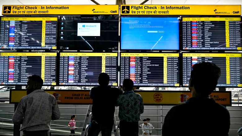 Display screens showing information on flights reflect error messages amid global IT outage.