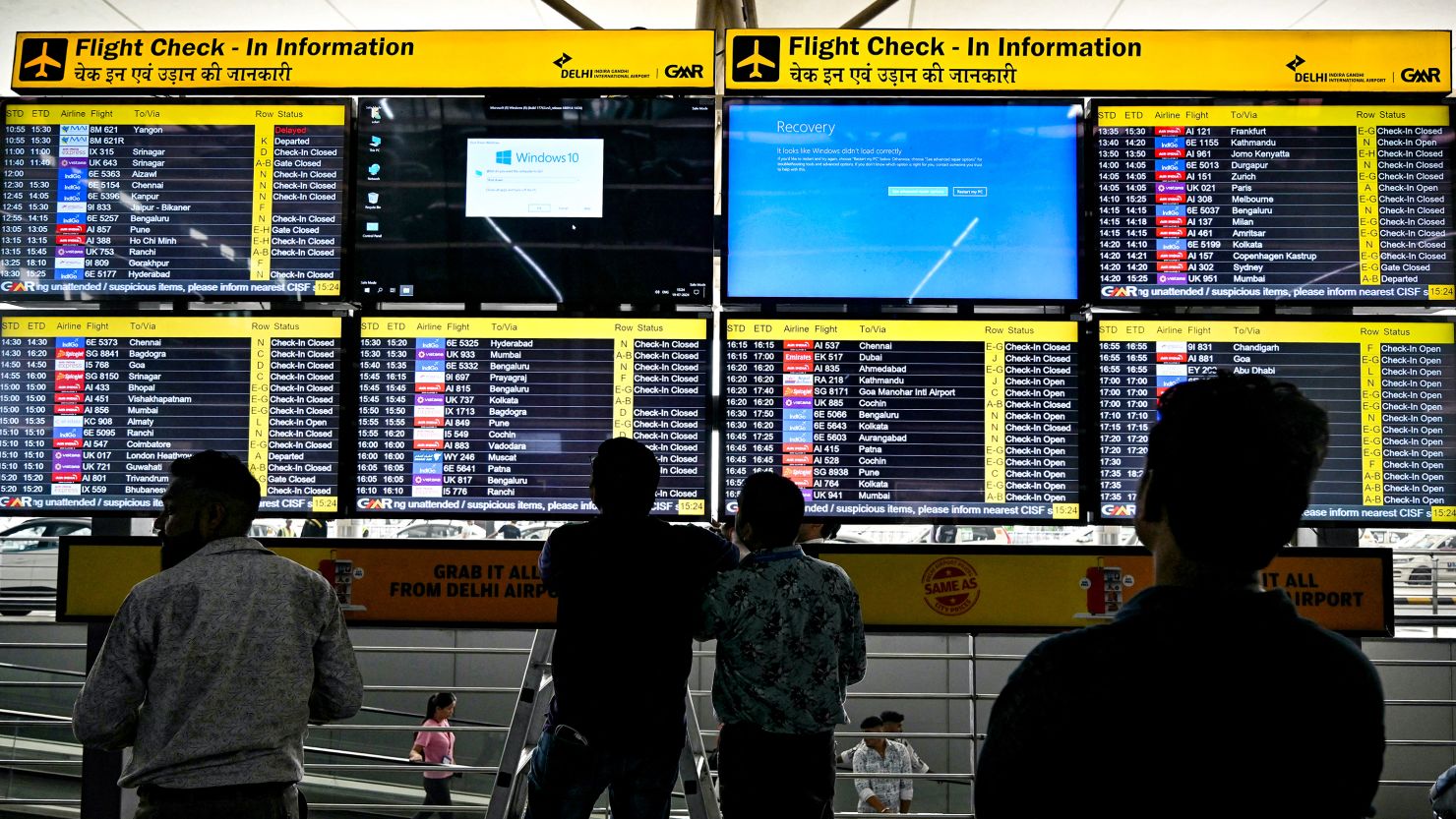 Display screens showing information on flights reflect error messages amid global IT outage.