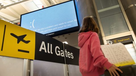 A screen with a restart message at John F. Kennedy International Airport (JFK) in New York, US, on Friday, July 19, 2024. Airlines around the world experienced disruption on an unprecedented scale after a widespread global computer outage grounded planes and created chaos at airports.