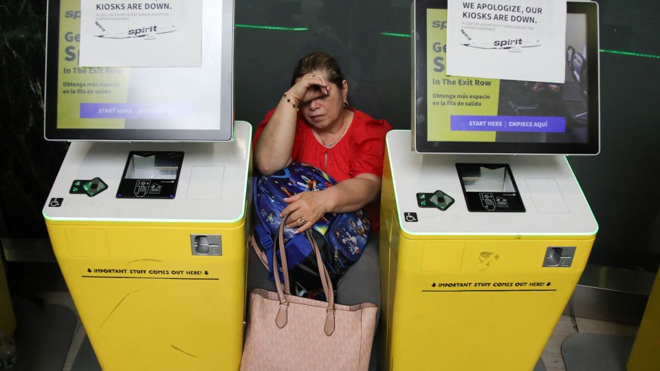 A woman waits for her flight Friday after a global outage affected LaGuardia Airport in New York. - Leonardo Munoz/AFP/Getty Images