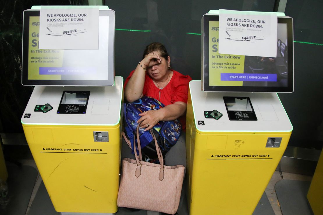 A woman waits for her flight Friday after a global outage affected LaGuardia Airport in New York.