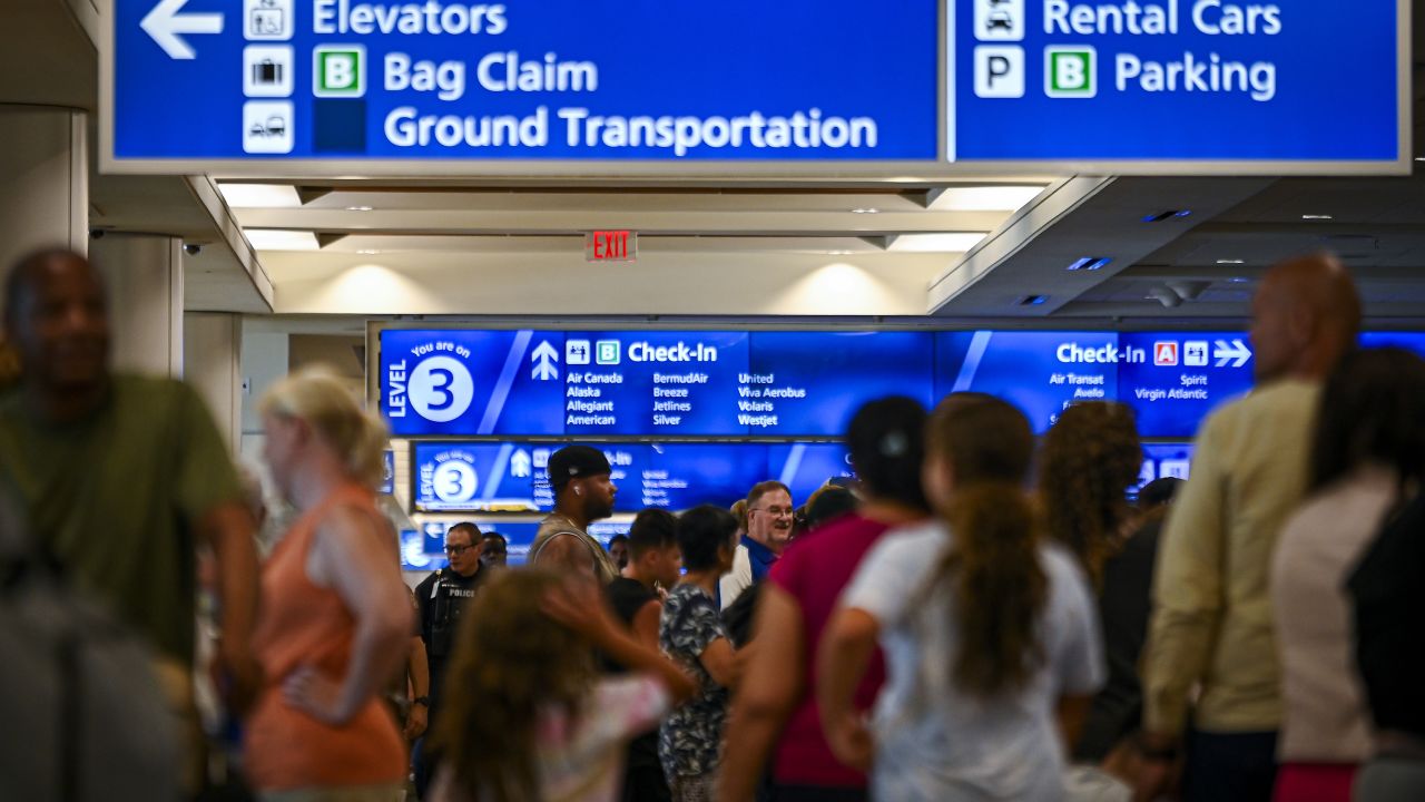 ORLANDO, FLORIDA - JULY 19: Passengers wait on long queues at check-in counters due to the global communications outage caused by CrowdStrike at Orlando International Airport on July 19, 2024, in Orlando, Florida. Businesses and airlines worldwide continue to be affected by a global technology outage attributed to a software update administered by CrowdStrike, a cybersecurity firm whose software is used by various industries around the world.  (Photo by Miguel J. Rodriguez Carrillo/Getty Images)