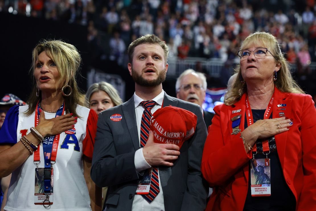 Delegates from Nebraska stand for the National Anthem on the first day of the Republican National Convention at the Fiserv Forum in Milwaukee, Wisconsin on July 15, 2024.