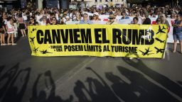 Protesters hold a banner which reads as "Let's change course" as they take part in a demonstration against overtourism and housing prices on the island of Mallorca in Palma de Mallorca on July 21, 2024. (Photo by JAIME REINA / AFP) (Photo by JAIME REINA/AFP via Getty Images)