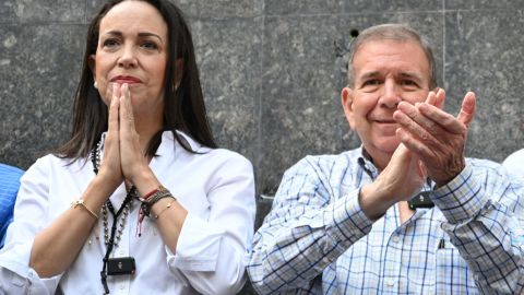 Venezuelan presidential candidate Edmundo Gonzalez Urrutia (R) applauds next to opposition leader Maria Corina Machado during a rally with Christian faithful in Caracas on July 21, 2024. Venezuela will hold its presidential election on July 28. (Photo by Raul ARBOLEDA / AFP) (Photo by RAUL ARBOLEDA/AFP via Getty Images)