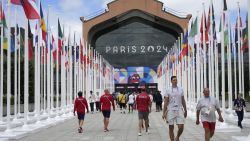 Participants of the Paris 2024 Olympics and Paralympics game walk in front of the cafeteria of the Olympic Village, in Saint-Denis, northern Paris, on July 22, 2024, ahead of the opening ceremony of Paris 2024 Olympic and Paralympic Games. (Photo by Michel Euler / POOL / AFP) (Photo by MICHEL EULER/POOL/AFP via Getty Images)