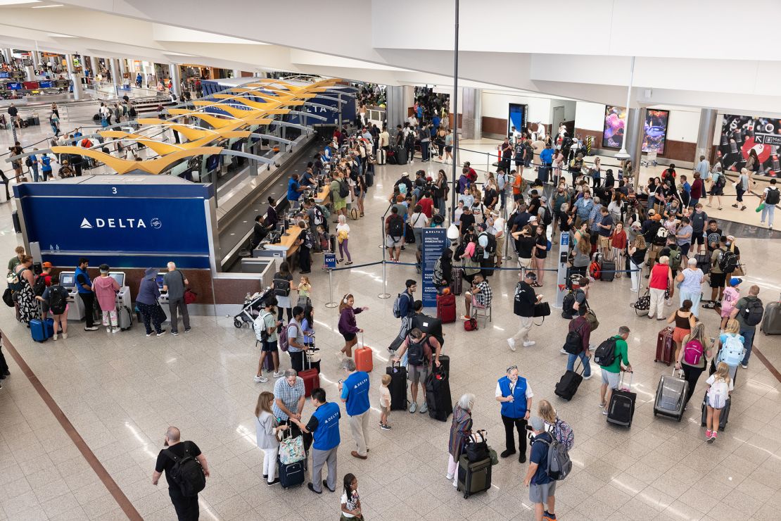 Airline passengers line up for agent assistance at Hartsfield-Jackson Atlanta International Airport.