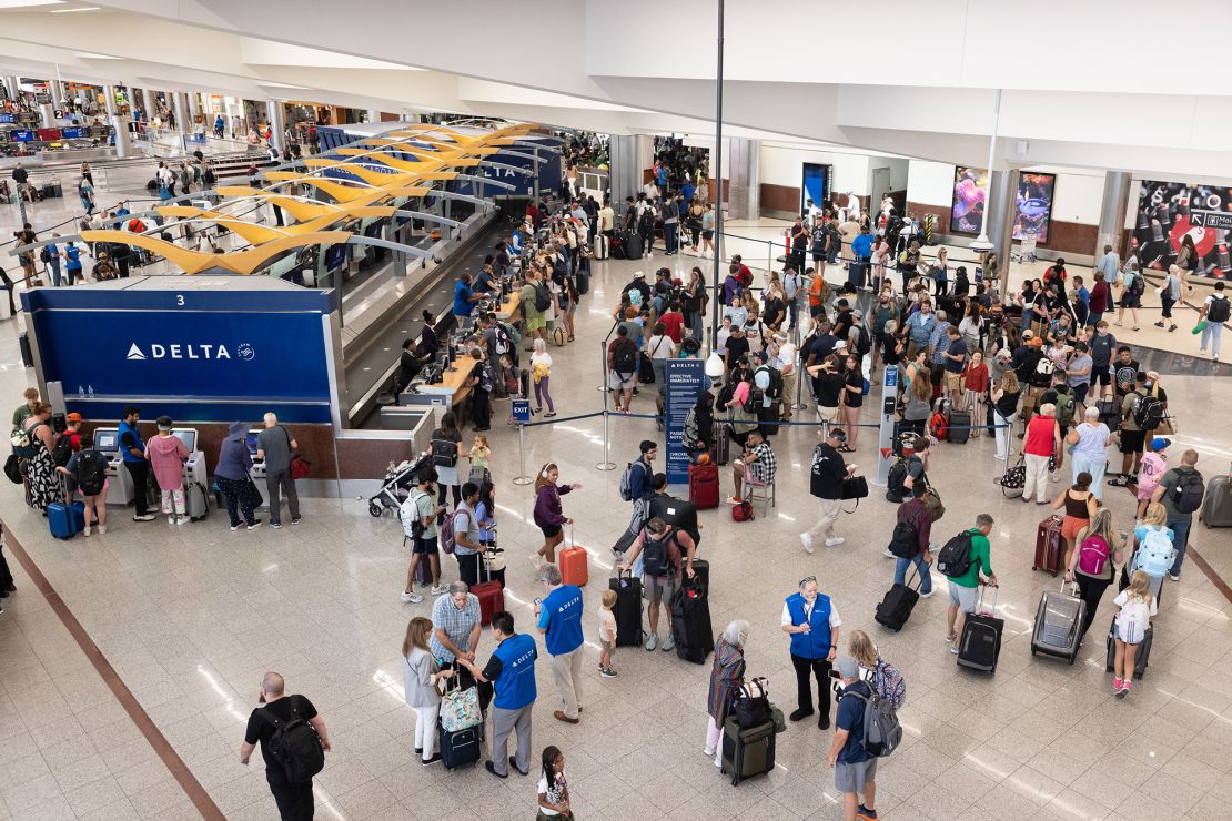 Passengers line up at Hartsfield-Jackson Atlanta International Airport. Uncertainties have made last-minute airfare deals more abundant this summer, experts say.