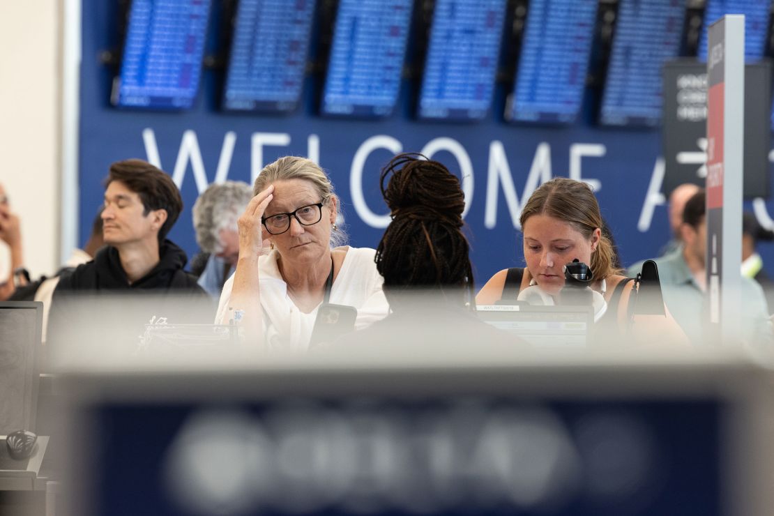 After multiple canceled flights to Washington D.C., Delta Airlines passengers Patty, left, and Alice Crump get ticketing assistance from an agent at Hartsfield-Jackson Atlanta International Airport on Monday.