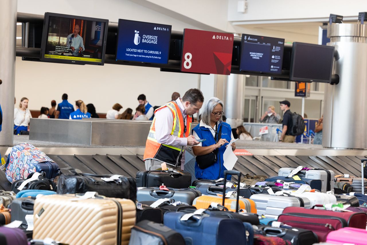 Delta employees try to locate passengers' luggage after cancelled and delayed flights at Hartsfield-Jackson Atlanta International Airport in July 22.