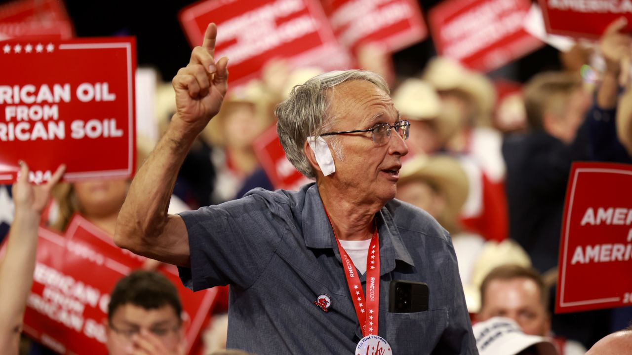 MILWAUKEE, WISCONSIN - JULY 17: A person wearing a 'bandage' on his ear watches on the third day of the Republican National Convention at the Fiserv Forum on July 17, 2024 in Milwaukee, Wisconsin. Delegates, politicians, and the Republican faithful are in Milwaukee for the annual convention, concluding with former President Donald Trump accepting his party's presidential nomination. The RNC takes place from July 15-18.  (Photo by Joe Raedle/Getty Images)