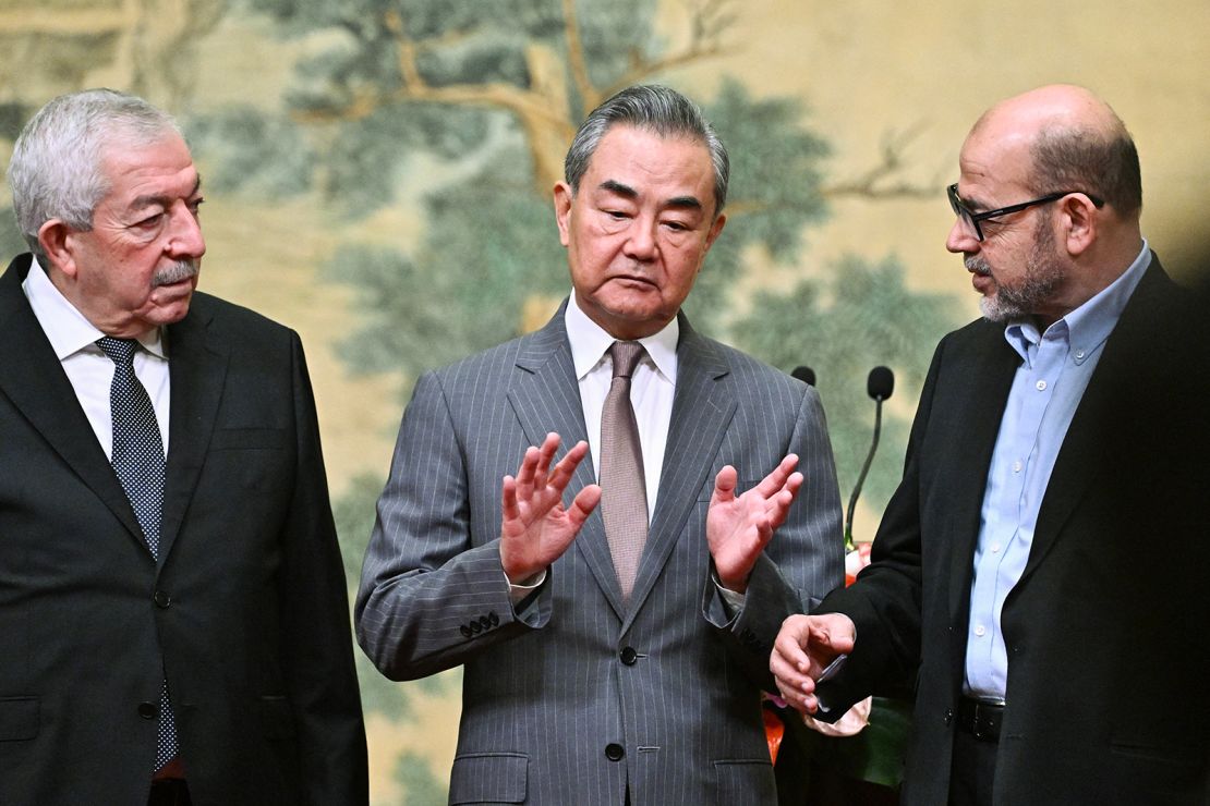 Mahmoud al-Aloul, Vice Chairman of the Central Committee of Fatah, China's Foreign Minister Wang Yi, and Mussa Abu Marzuk, a senior member of Hamas, in Beijing on July 23, 2024.