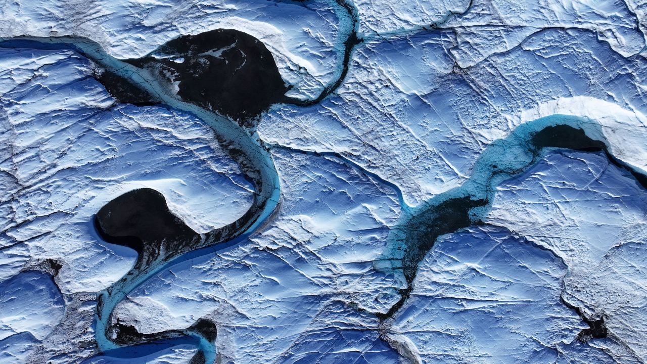 Rivulets of meltwater snake across the surface of the melting Isunnguata Sermia glacier of the Greenland Ice Sheet on July 11, 2024 near Kangerlussuaq, Greenland.