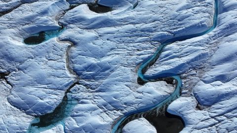 KANGERLUSSUAQ, GREENLAND - JULY 11: In this aerial view rivulets of meltwater snake across the surface of the melting Isunnguata Sermia glacier of the Greenland Ice Sheet on July 11, 2024 near Kangerlussuaq, Greenland. A team of scientists has observed that increasing amounts of meltwater on the surface of the glacier making their way to the glacial flows underneath are leading to a rising output of methane from Isunnguata Sermia. Earlier this year other scientists published a study in which they concluded that Greenland’s glaciers, which all stem from the Greenland Ice Sheet, have retreated about 20% more than previously estimated. Of the 200 glaciers included in the study, only one has grown since 1985. Overall, the amount of glacial ice melting globally has increased markedly over the past 30 years as global warming continues to intensify. According to the European Space Agency, the Earth lost 28 trillion tons of ice between 1994 and 2017, enough to cover the entire United Kingdom with an ice sheet 100 meters thick. Since 2017 the rate of ice loss has increased to 1.3 trillion tons annually, up from 0.8 trillion tons in the 1990s. According to the Programme for Monitoring of the Greenland Ice Sheet (PROMICE), the Greenland Ice Sheet has been losing mass continuously since 1996, with an accumulated loss since 1986 approaching 6,000 metric gigatons, or six trillion tons. (Photo by Sean Gallup/Getty Images)