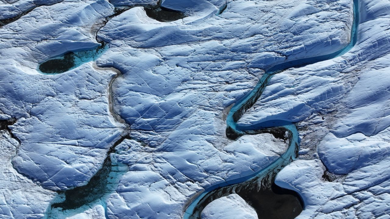 KANGERLUSSUAQ, GREENLAND - JULY 11: In this aerial view rivulets of meltwater snake across the surface of the melting Isunnguata Sermia glacier of the Greenland Ice Sheet on July 11, 2024 near Kangerlussuaq, Greenland. A team of scientists has observed that increasing amounts of meltwater on the surface of the glacier making their way to the glacial flows underneath are leading to a rising output of methane from Isunnguata Sermia. Earlier this year other scientists published a study in which they concluded that Greenland’s glaciers, which all stem from the Greenland Ice Sheet, have retreated about 20% more than previously estimated. Of the 200 glaciers included in the study, only one has grown since 1985. Overall, the amount of glacial ice melting globally has increased markedly over the past 30 years as global warming continues to intensify. According to the European Space Agency, the Earth lost 28 trillion tons of ice between 1994 and 2017, enough to cover the entire United Kingdom with an ice sheet 100 meters thick. Since 2017 the rate of ice loss has increased to 1.3 trillion tons annually, up from 0.8 trillion tons in the 1990s. According to the Programme for Monitoring of the Greenland Ice Sheet (PROMICE), the Greenland Ice Sheet has been losing mass continuously since 1996, with an accumulated loss since 1986 approaching 6,000 metric gigatons, or six trillion tons. (Photo by Sean Gallup/Getty Images)