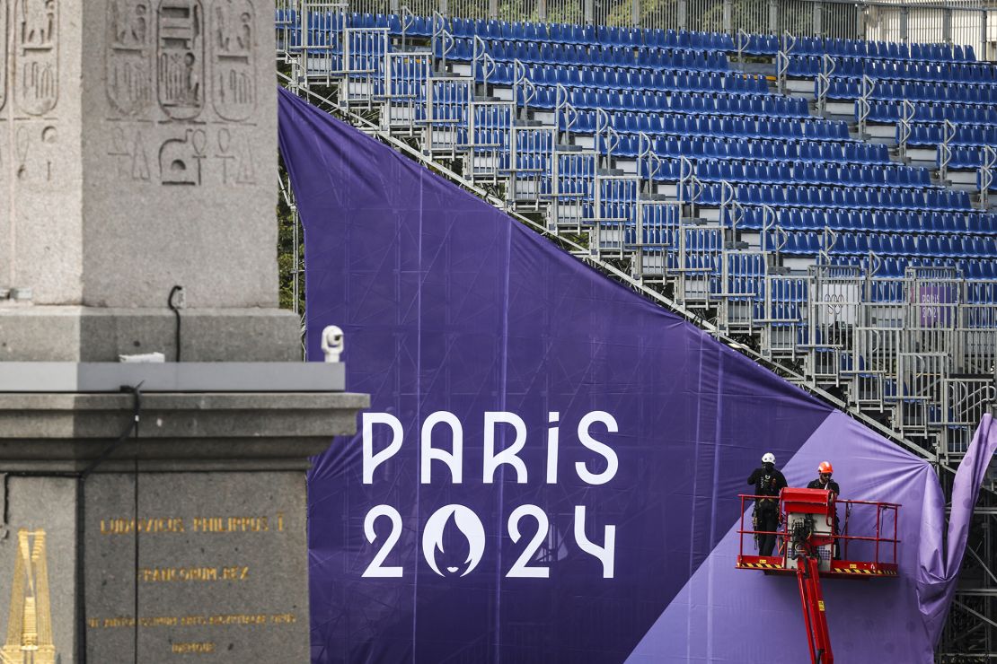 Workmen adjust banners on the 3x3 basketball venue located at La Concorde, in Paris, ahead of the 2024 Olympic Games.