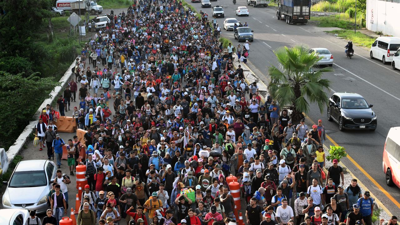 Hundreds of migrants, mostly from Central America and Venezuela, set out in a US-bound caravan to escape poverty and violence, on the outskirts of Tapachula, State of Chiapas, Mexico, on July 23, 2024. Tapachula, near the country's southern border with Guatemala, sees hundreds of thousands of undocumented migrants passing through each year after they cross the Guatemalan-Mexican border heading towards the United States to escape poverty and violence. (Photo by ISAAC GUZMAN / AFP) (Photo by ISAAC GUZMAN/AFP via Getty Images)