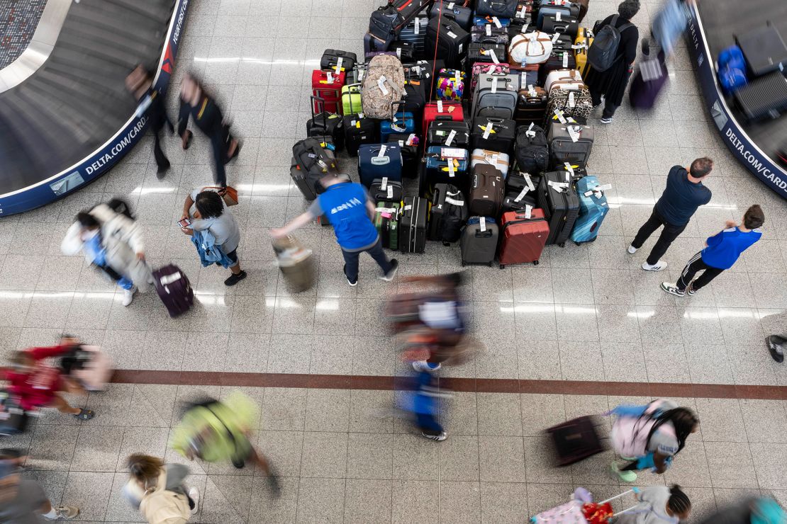 Travelers wait for their luggage at the Delta baggage claim at Hartsfield-Jackson Atlanta International Airport (ATL) in Atlanta, Georgia, US, on Tuesday, July 23, 2024.