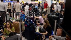 CRAWLEY, ENGLAND - JULY 19: Passengers queue at Gatwick Airport amid a global IT outage on July 19, 2024 in Crawley, United Kingdom. Businesses, travel companies and Microsoft users across the globe were among those affected by a tech outage today. (Photo by Jack Taylor/Getty Images)