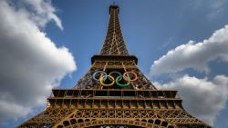 TOPSHOT - A photo shows the Olympic rings on the Eiffel Tower ahead of the Paris 2024 Olympic Games in Paris, on July 24, 2024. (Photo by Fabrice COFFRINI / AFP) (Photo by FABRICE COFFRINI/AFP via Getty Images)