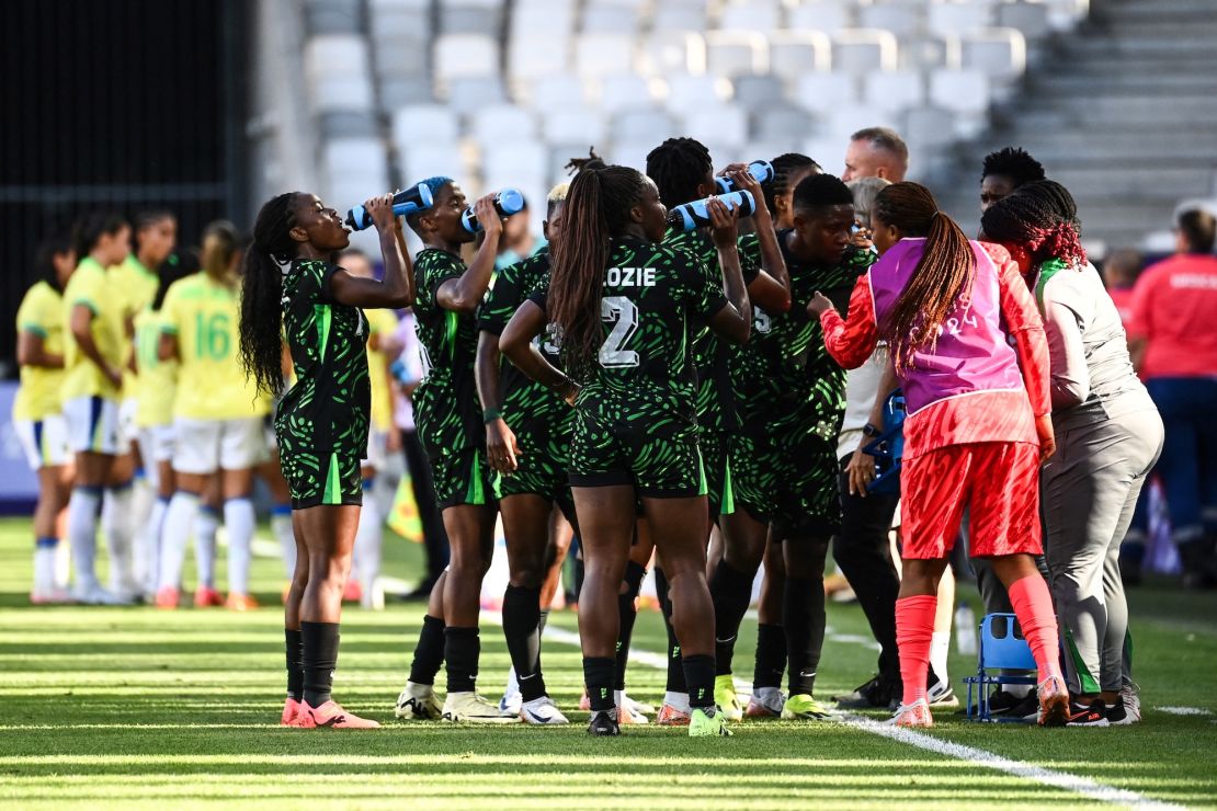 Staying hydrated is key for athletes. Here, the Nigerian women's soccer team takes a water break on July 25 in a match against Brazil in Bordeaux, France, during the 2024 Olympic Games.