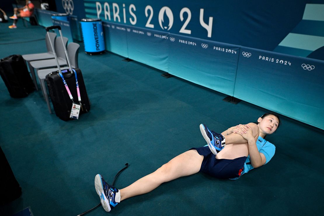 Spain's Maria Xiao stretches as she takes part in a table tennis training session on the eve of the opening ceremony of the Paris 2024 Olympic Games.