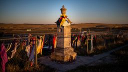 Wind flutters around the peace offerings of tobacco ties that line the fence at the Wounded Knee Memorial on Pine Ridge Reservation in South Dakota, on October 20, 2014.
