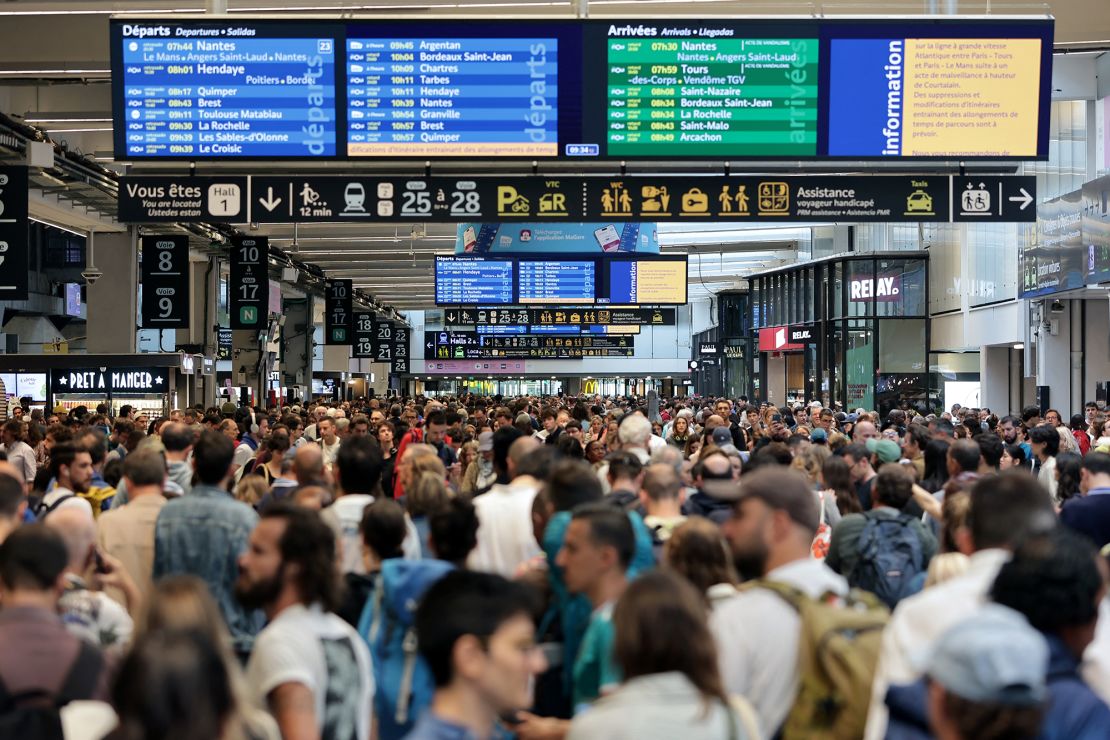 Passengers gather around the departure boards at the Gare Montparnasse train station in Paris.