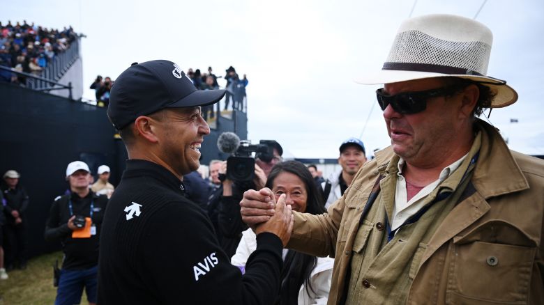TROON, SCOTLAND - JULY 21: Xander Schauffele of the United States is congratulated by his Father, Stefan Schauffele on the 18th green on day four of The 152nd Open championship at Royal Troon on July 21, 2024 in Troon, Scotland. (Photo by Stuart Franklin/R&A/R&A via Getty Images)