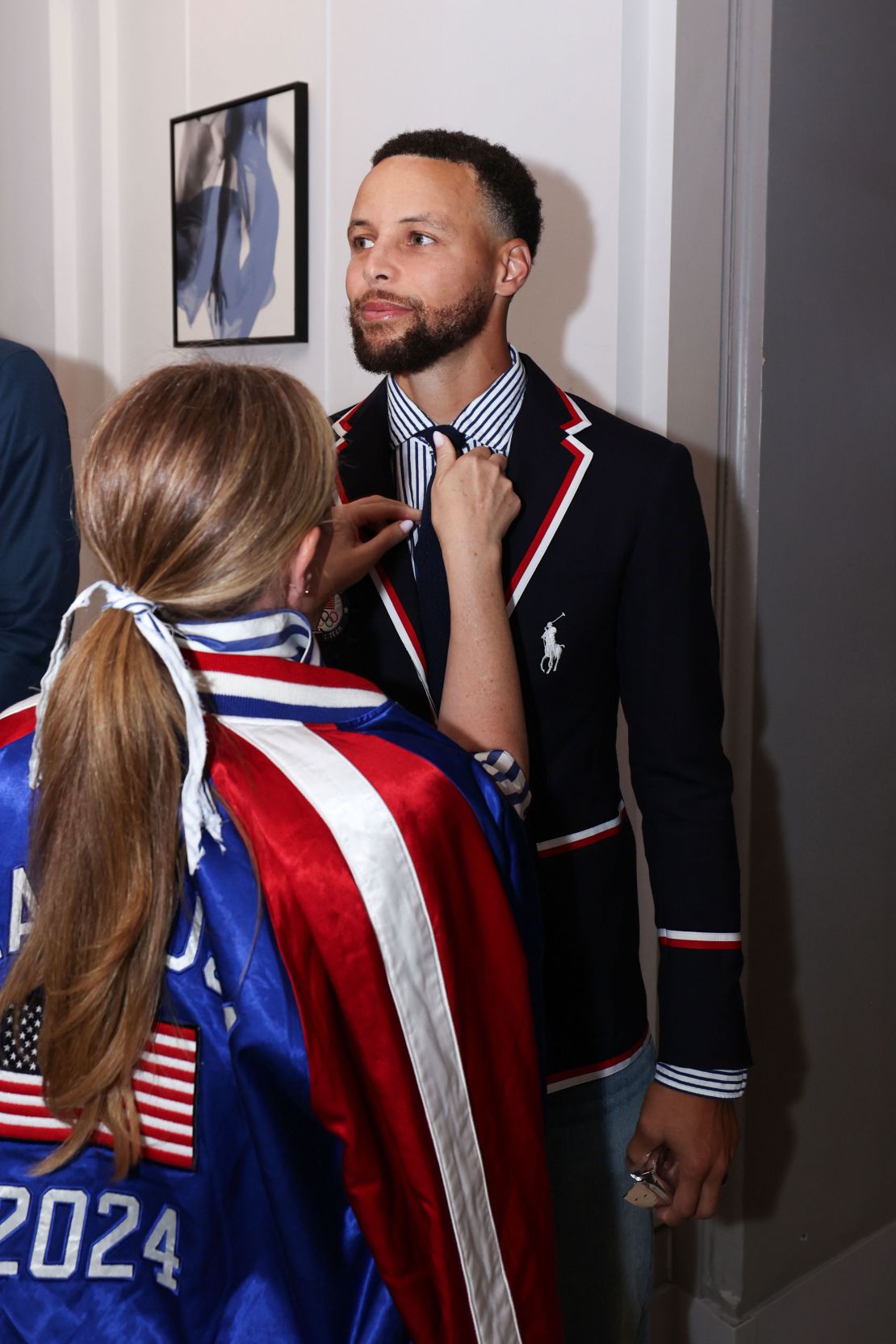 Basketball player Stephen Curry is styled in the opening ceremony blazer and tie.