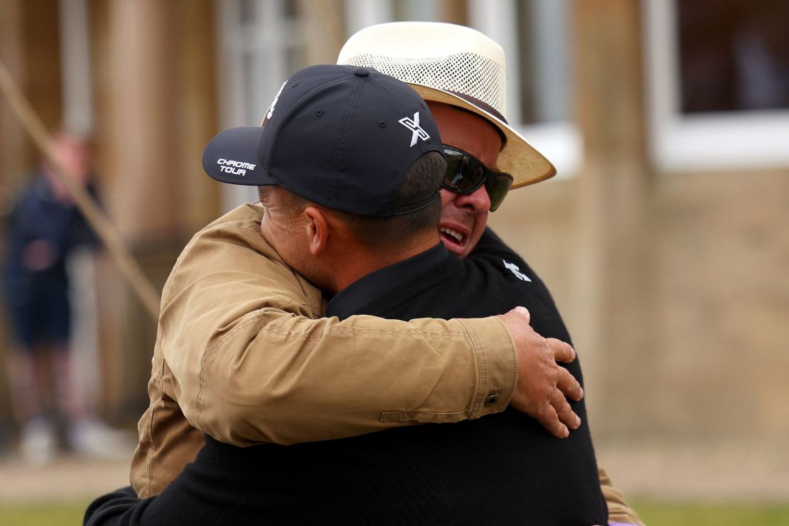 Father and son embrace after the Open triumph.