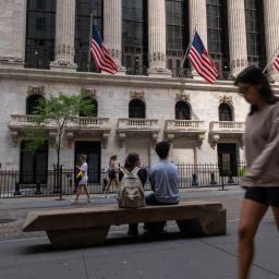 People walk by the outside of the New York Stock Exchange (NYSE) on July 22, 2024 in New York City.