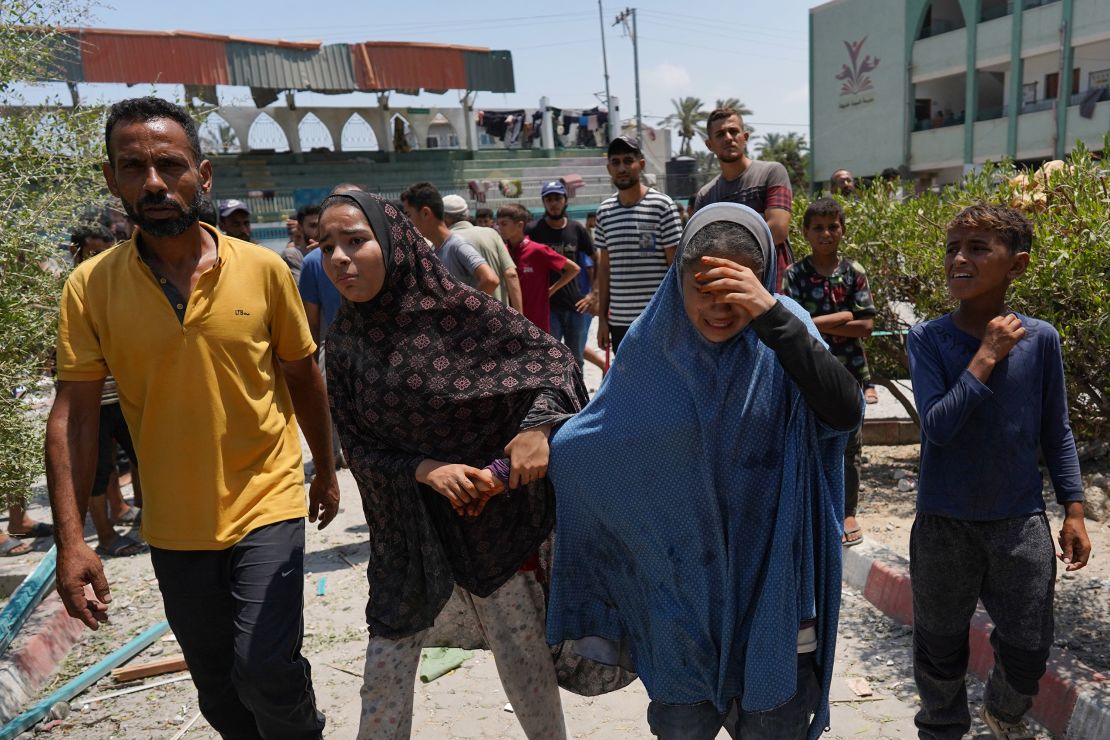 Palestinians flee from a school where they had taken refuge, after it was hit by an Israeli strike, in Deir el-Balah in the central Gaza Strip on July 27, 2024, amid the ongoing conflict between Israel and the Palestinian militant group Hamas.