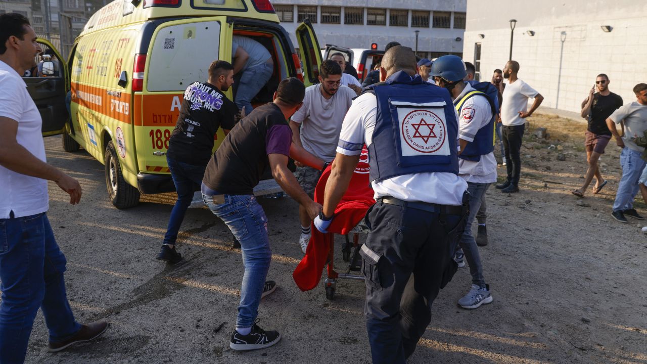 Israeli security forces and medics transport casualties along with local residents, at a site where a reported strike from Lebanon fell in Majdal Shams village in the Israeli-annexed Golan area on July 27, 2024.