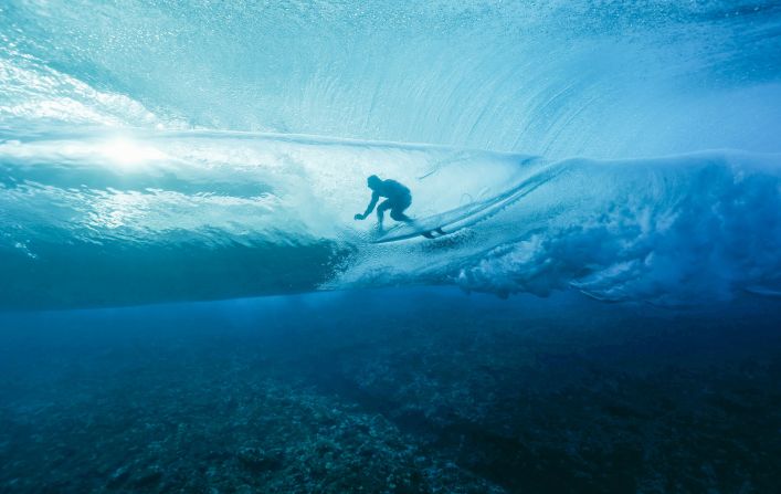 France's Joan Duru gets into the barrel during the first round of the surfing competition on July 27. The surfing events are <a >taking place in Tahiti</a>, far away from Paris.