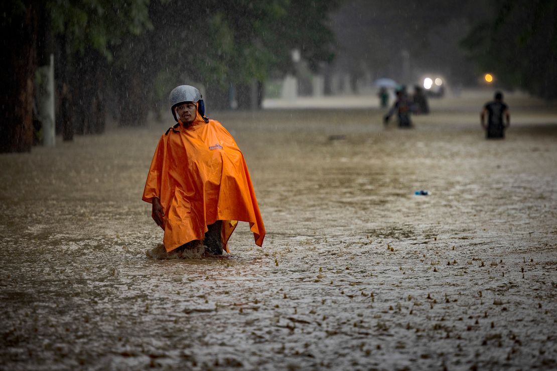 Residents wade in a flooded road caused by Typhoon Gaemi and monsoon rains on July 24, 2024 in Marikina, Metro Manila, Philippines.