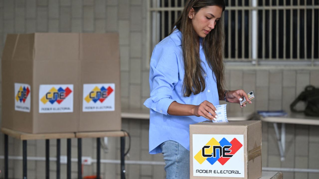 A woman casts her vote during the Venezuelan presidential election, in Caracas on July 28, 2024. Venezuelans vote Sunday between continuity in President Nicolas Maduro or change in rival Edmundo Gonzalez Urrutia amid high tension following the incumbent's threat of a "bloodbath" if he loses, which polls suggest is likely. (Photo by RAUL ARBOLEDA / AFP) (Photo by RAUL ARBOLEDA/AFP via Getty Images)