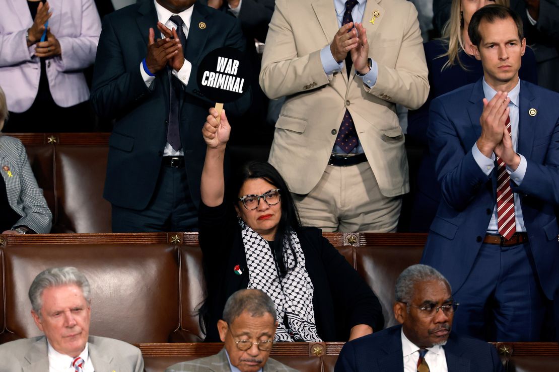 Rep. Rashida Tlaib holds a sign reading "war criminal" during Netanyahu's address.