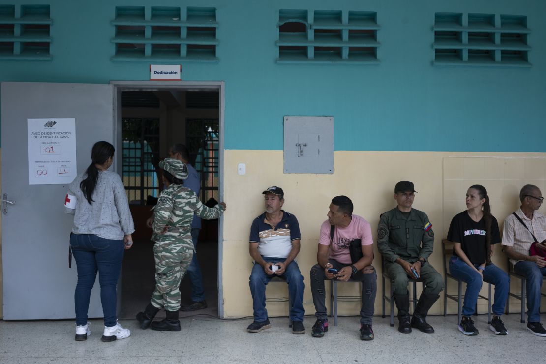 Voters wait in line to cast a ballot at a polling station during the presidential election in Caracas, Venezuela, on Sunday, July 28, 2024. Voters began lining up at polling stations across the country early Sunday to chose between President Nicolas Maduro, whose 11-year grip on power spanned one of the worst humanitarian and economic crises in modern history, and a candidate who isn't even on the ballot. Photographer: Andrea Hernandez Briceno/Bloomberg via Getty Images