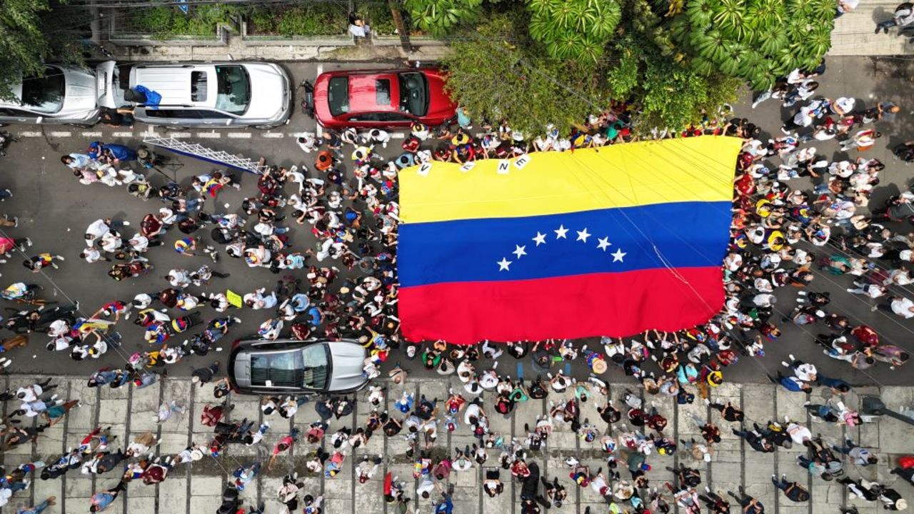 Aerial view of a Venezuelan flag carried by Venezuelans living in Mexico outside the embassy of Venezuela in Mexico City on July 28, 2024, during election day in their country. Venezuelans vote Sunday between continuity in President Nicolas Maduro or change in rival Edmundo Gonzalez Urrutia amid high tension following the incumbent's threat of a "bloodbath" if he loses. (Photo by Alfredo ESTRELLA / AFP) (Photo by ALFREDO ESTRELLA/AFP via Getty Images)