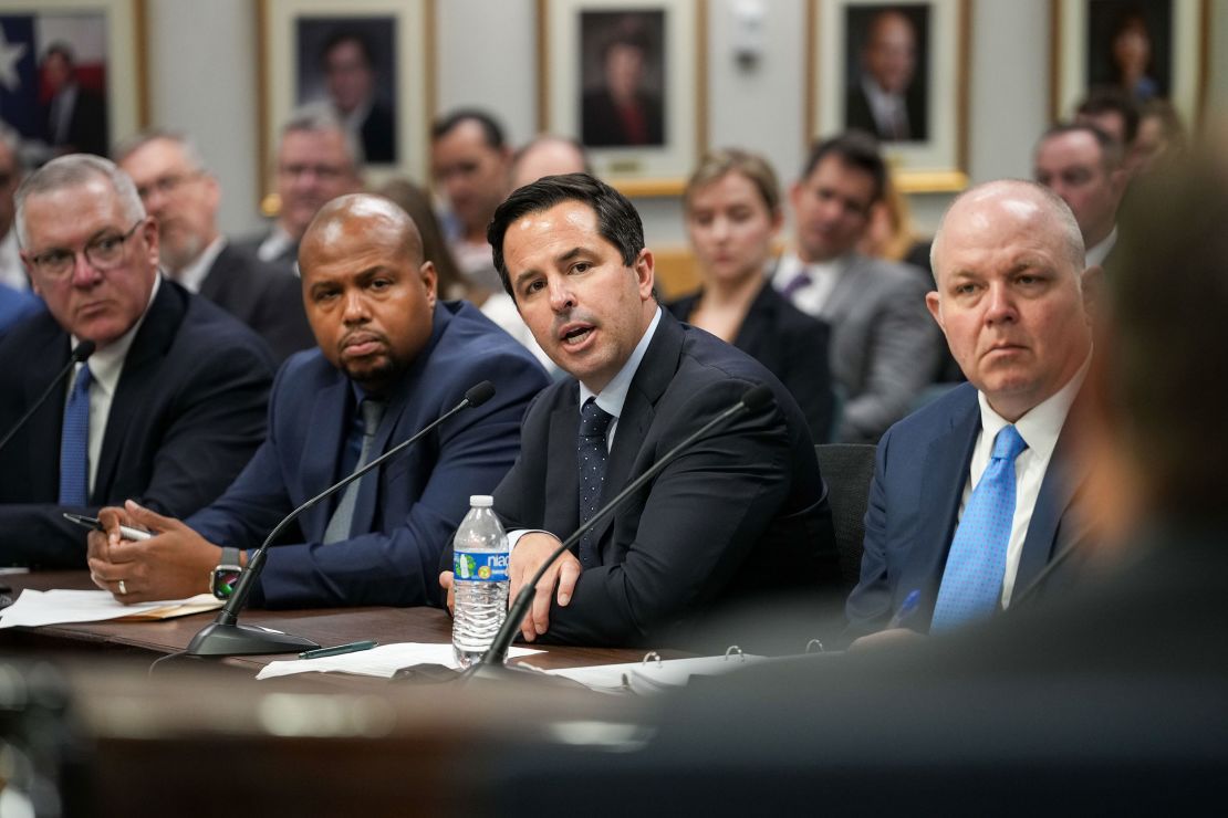 CenterPoint Energy CEO Jason Wells, center, speaks during a meeting on July 25 at the Commissioners Hearing Room in Austin, Texas.