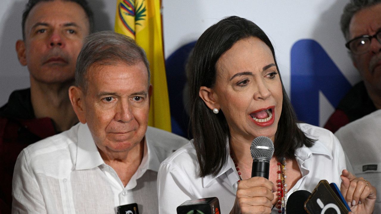 Venezuelan opposition leader Maria Corina Machado talks to the media, accompanied by opposition presidential candidate Edmundo Gonzalez Urrutia, following the presidential election results in Caracas on July 29, 2024. Venezuela's opposition coalition on Monday rejected the election victory claimed by President Nicolas Maduro and announced by a loyalist electoral authority, saying it had garnered 70 percent of the vote, not 44 percent as reported by the authority.