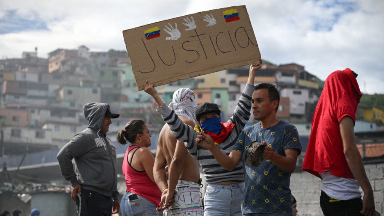 TOPSHOT - An opponent of Venezuelan President Nicolas Maduro's government holds a banner that reads "Justice" during a protest at the El Valle neighborhood in Caracas on July 29, 2024, a day after the Venezuelan presidential election. Protests erupted in parts of Caracas Monday against the re-election victory claimed by Venezuelan President Nicolas Maduro but disputed by the opposition and questioned internationally, AFP journalists observed. (Photo by Federico PARRA / AFP) (Photo by FEDERICO PARRA/AFP via Getty Images)