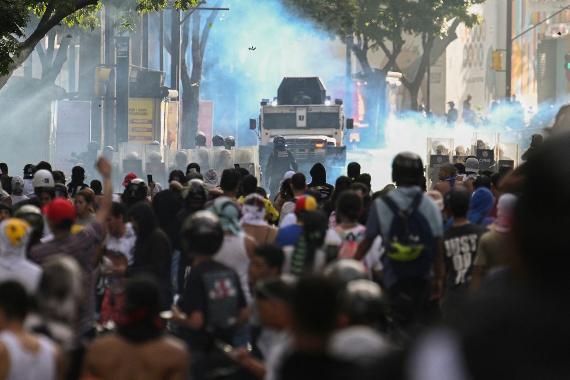 Demonstrators clash with police close to an armored police car during a protest against Venezuelan President Nicolas Maduro in Caracas, Venezuela, on July 29, 2024, a day after the Venezuelan presidential election.