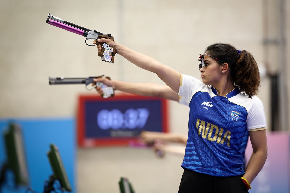 Manu Bhaker of India competes in a mixed team 10m air pistol shooting match for the bronze medal during the Paris 2024 Olympic Games at the Chateauroux Shooting Centre on July 30, 2024.