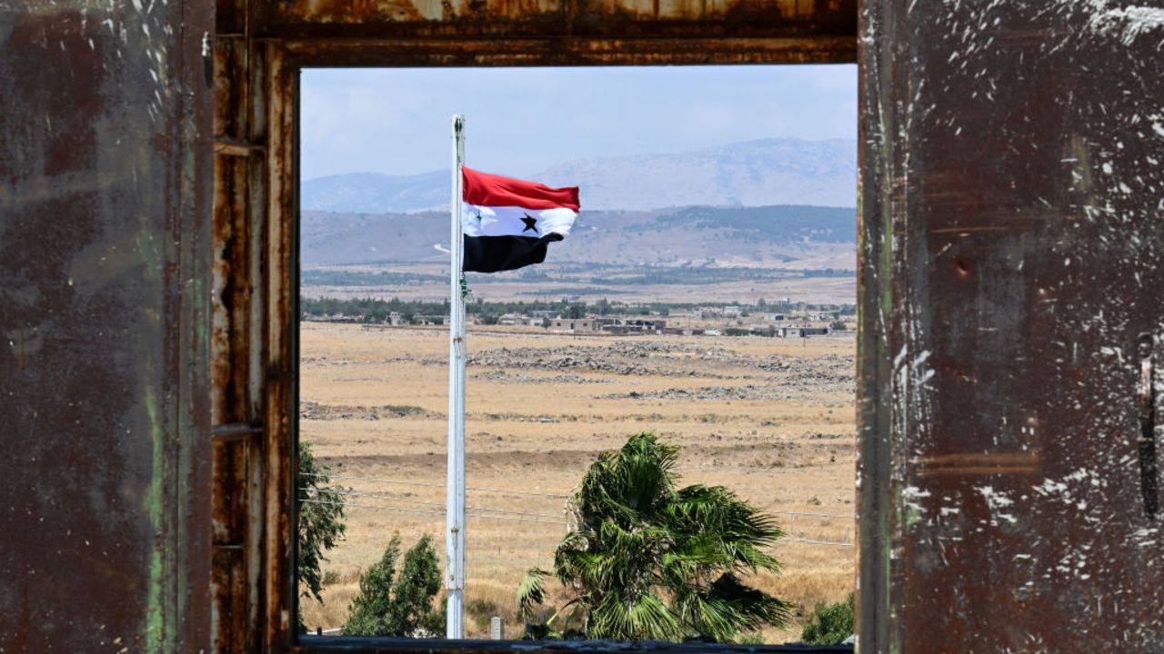 A Syrian flutters in town of Quneitra, on July 30, 2024, overlooking the Israeli-annexed side of the Golan Heights. A strike on the Druze Arab town of Majdal Shams in the Israeli-annexed Golan Heights on July 27, whose victims were aged between 10 and 16, was blamed on Lebanon's Hezbollah, but the Iran-backed group has denied any connection to the attack. (Photo by LOUAI BESHARA / AFP) (Photo by LOUAI BESHARA/AFP via Getty Images)