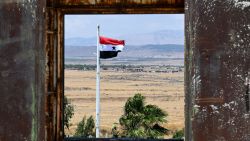 A Syrian flutters in town of Quneitra, on July 30, 2024, overlooking the Israeli-annexed side of the Golan Heights. A strike on the Druze Arab town of Majdal Shams in the Israeli-annexed Golan Heights on July 27, whose victims were aged between 10 and 16, was blamed on Lebanon's Hezbollah, but the Iran-backed group has denied any connection to the attack. (Photo by LOUAI BESHARA / AFP) (Photo by LOUAI BESHARA/AFP via Getty Images)