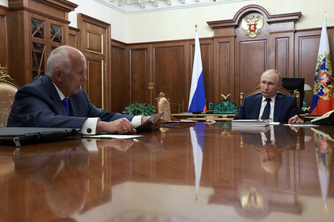 Russia's President Vladimir Putin (R) attends a meeting with Russia's state-owned defence corporation Rostec CEO Sergei Chemezov in Moscow on July 30, 2024.