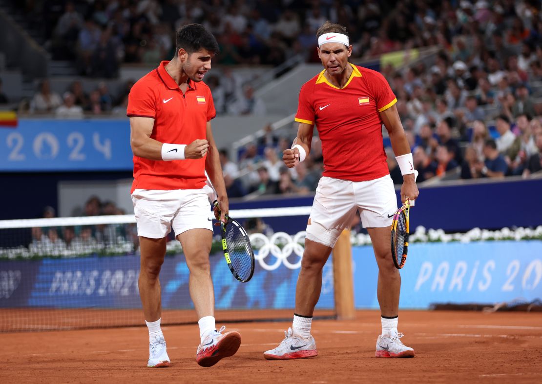 PARIS, FRANCE - JULY 27: Rafael Nadal (R) and his partner Carlos Alcaraz of Team Spain celebrate their victory over Andres Molteni and Maximo Gonzalez of Team Argentina during their first round men's doubles match on the first day of the Paris 2024 Olympic Games at Roland Garros on July 27, 2024 in Paris, France. (Photo by Clive Brunskill/Getty Images)