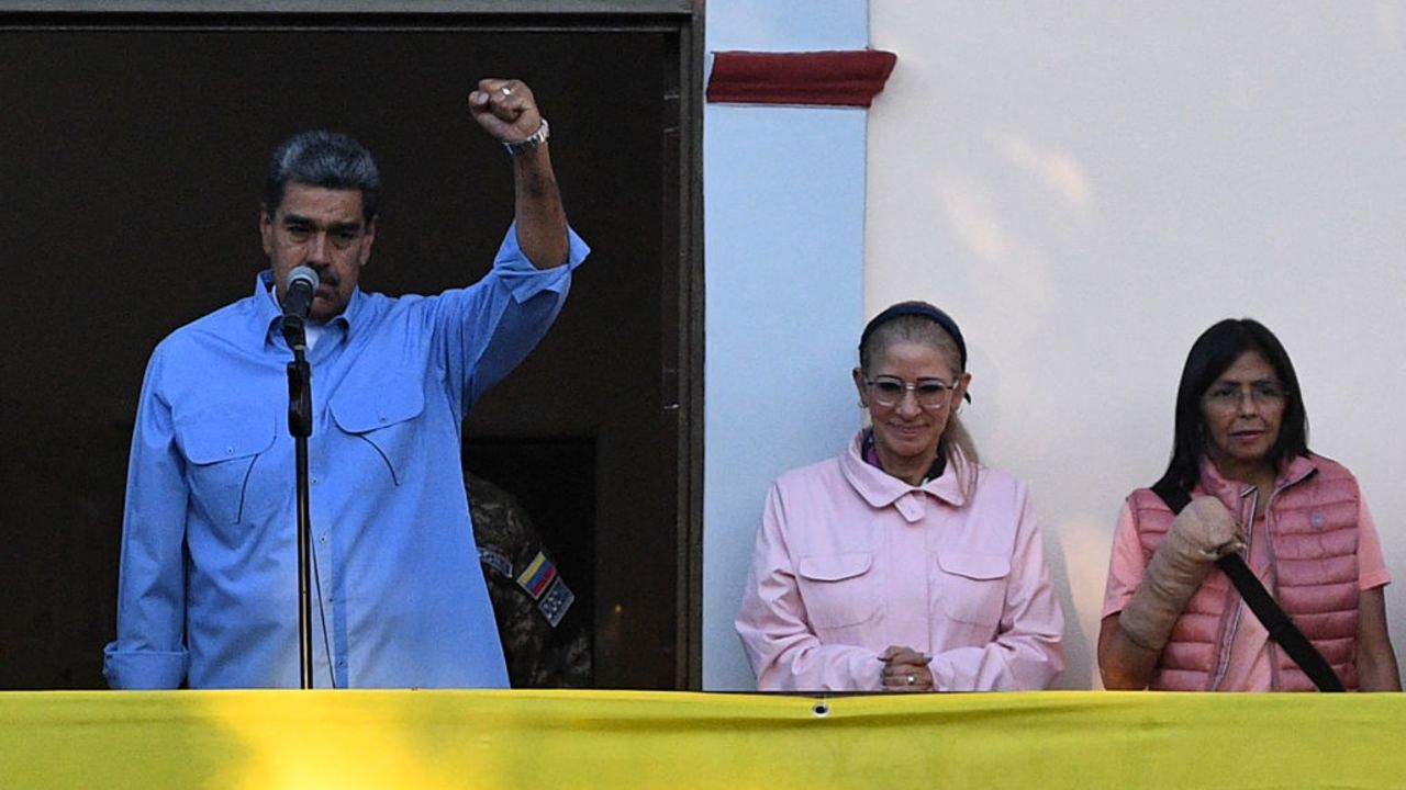 Venezuelan President Nicolas Maduro (L) speaks next to First Lady Cilia Flores (C) and Vice President Delcy Rodriguez during a rally at the Miraflores presidential palace in Caracas on July 30, 2024. Venezuela braced for new demonstrations after four people died and dozens were injured on the eve when the authorities broke up protests against President Nicolas Maduro's claim of victory in the country's hotly disputed weekend election. (Photo by Federico Parra / AFP) (Photo by FEDERICO PARRA/AFP via Getty Images)